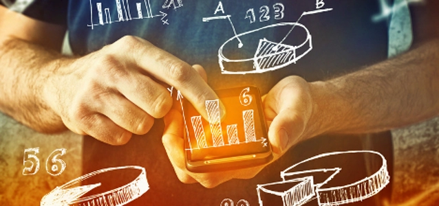 man-using-mobile-phone-with-drawings-of-charts