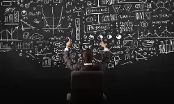 businessman-sitting-in-front-of-blackboard